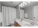 Neutral bathroom features a double sink vanity and shower with curtain at 2109 Hemlock Hill Dr, Durham, NC 27703