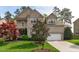 Charming two-story brick home featuring a well-manicured lawn and attached two-car garage at 2109 Hemlock Hill Dr, Durham, NC 27703