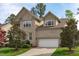An exterior view of a two-story brick home with an attached two-car garage and a well-kept lawn at 2109 Hemlock Hill Dr, Durham, NC 27703