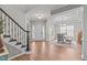 Spacious foyer with hardwood floors, staircase, and dining area, perfect for welcoming guests at 2109 Hemlock Hill Dr, Durham, NC 27703
