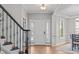 Bright foyer with hardwood floors, staircase, and views into other rooms at 2109 Hemlock Hill Dr, Durham, NC 27703