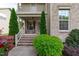 Inviting front porch with brick steps, decorative shrubbery, and charming exterior details at 2109 Hemlock Hill Dr, Durham, NC 27703