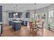 Stylish kitchen with blue cabinets, a center island, stainless appliances, and an adjacent dining area with backyard access at 2109 Hemlock Hill Dr, Durham, NC 27703