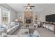 Inviting living room with stone fireplace, plush seating, and ample natural light, creating a cozy and welcoming space at 2109 Hemlock Hill Dr, Durham, NC 27703