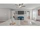 This cozy living room features plush seating, a ceiling fan, and a mounted TV for entertaining at 2109 Hemlock Hill Dr, Durham, NC 27703