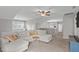 Open living room area featuring plush sectional couch, ceiling fan, and lots of natural light at 2109 Hemlock Hill Dr, Durham, NC 27703
