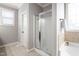 Bathroom with a glass-enclosed shower and a decorative window above the tub at 2113 Conroy Way, Willow Springs, NC 27592
