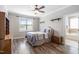 Bright bedroom with a ceiling fan, wood-look flooring, and an en-suite bathroom at 2113 Conroy Way, Willow Springs, NC 27592