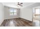 Light-filled bedroom features hardwood floors, a ceiling fan, and access to the bathroom at 2113 Conroy Way, Willow Springs, NC 27592