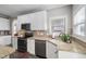 Modern kitchen with white cabinets, stainless steel appliances, and granite countertops at 2113 Conroy Way, Willow Springs, NC 27592