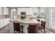 Bright kitchen features granite countertops, white cabinets, stainless steel appliances and a breakfast bar at 2113 Conroy Way, Willow Springs, NC 27592
