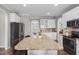 Spacious kitchen with a large island, granite countertops, and stainless steel appliances at 2113 Conroy Way, Willow Springs, NC 27592