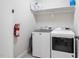 Laundry room with modern washer and dryer units, and storage shelf at 2113 Conroy Way, Willow Springs, NC 27592
