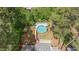 Aerial view of the property featuring a large backyard with a pool and a shed surrounded by trees at 2120 Hillock Dr, Raleigh, NC 27612