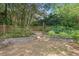A brick retaining wall and wooden fence add charm to the level backyard area of the property at 2120 Hillock Dr, Raleigh, NC 27612