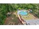 Aerial view of backyard, featuring a charming above-ground pool with a deck, surrounding by beautiful greenery at 2120 Hillock Dr, Raleigh, NC 27612