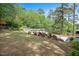 Expansive backyard featuring lush greenery, mature trees, and an above-ground pool with deck at 2120 Hillock Dr, Raleigh, NC 27612