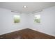 Bright bedroom features hardwood floors and two windows providing ample natural light at 2120 Hillock Dr, Raleigh, NC 27612