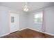 Bedroom features hardwood floors, ceiling fan, and large window with pink curtains at 2120 Hillock Dr, Raleigh, NC 27612