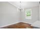 Bright dining room features hardwood floors, modern light fixture, and a large window at 2120 Hillock Dr, Raleigh, NC 27612