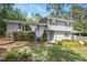 Charming home featuring a well-manicured lawn, mature landscaping, and a painted front door at 2120 Hillock Dr, Raleigh, NC 27612