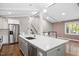 Bright kitchen features stainless steel appliances, white cabinets, a spacious island, and an open layout at 2120 Hillock Dr, Raleigh, NC 27612