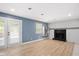 Living room with fireplace, French doors, a window shelf, and wood plank floors at 2120 Hillock Dr, Raleigh, NC 27612