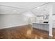 Open concept living area with vaulted ceiling, hardwood floors, and kitchen with island at 2120 Hillock Dr, Raleigh, NC 27612