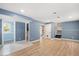 Bright living room boasts wood floors, fresh blue paint, and staircase access at 2120 Hillock Dr, Raleigh, NC 27612