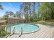 Backyard featuring an above ground pool with a deck, and landscaping at 2120 Hillock Dr, Raleigh, NC 27612