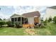 Backyard with a deck, grill, and lush landscaping at 2124 Castle Pines Dr, Raleigh, NC 27604