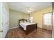 Bedroom with a dark wood frame bed, ceiling fan and windows providing light at 2124 Castle Pines Dr, Raleigh, NC 27604