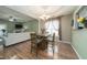 Cozy dining room with wood floors, stylish lighting, and access to the living room at 2124 Castle Pines Dr, Raleigh, NC 27604