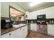 Modern kitchen with stainless steel appliances, granite countertops, and white cabinetry at 2124 Castle Pines Dr, Raleigh, NC 27604