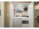 Laundry room featuring a washer and dryer and storage shelves at 2124 Castle Pines Dr, Raleigh, NC 27604