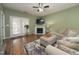 Inviting living room featuring a fireplace, wood flooring, and access to an outdoor space at 2124 Castle Pines Dr, Raleigh, NC 27604