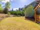 Expansive backyard offering lush lawn, mature trees, and a tranquil outdoor space at 2125 Toad Hollow Trl, Apex, NC 27502