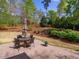 Landscaped backyard with a charming patio set, perfect for outdoor entertaining at 2125 Toad Hollow Trl, Apex, NC 27502