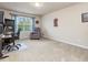 Spacious bedroom featuring neutral carpet, a comfortable chair, and natural light at 2125 Toad Hollow Trl, Apex, NC 27502