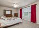 Comfortable bedroom with a decorative quilt and bright red curtains at 2125 Toad Hollow Trl, Apex, NC 27502