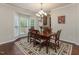 Elegant dining room features a bay window and a decorative chandelier at 2125 Toad Hollow Trl, Apex, NC 27502
