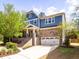 Charming two-story home featuring a brick and blue exterior with a two-car garage and manicured front yard at 2125 Toad Hollow Trl, Apex, NC 27502