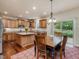 Well-equipped kitchen with stainless steel appliances, center island, and a dining area filled with natural light at 2125 Toad Hollow Trl, Apex, NC 27502
