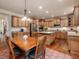 Gourmet kitchen with granite countertops, stainless steel appliances, a central island, and custom cabinetry at 2125 Toad Hollow Trl, Apex, NC 27502