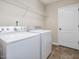 Well-lit laundry room with a side-by-side washer and dryer for easy chores at 2125 Toad Hollow Trl, Apex, NC 27502