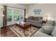 Cozy living room with large windows, comfortable furniture, and stylish decor at 2125 Toad Hollow Trl, Apex, NC 27502