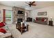 Inviting living room featuring stone fireplace, large windows, neutral carpet, and comfortable seating arrangements at 2125 Toad Hollow Trl, Apex, NC 27502
