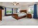 Spacious main bedroom features a ceiling fan, multiple windows, and ample closet space at 2125 Toad Hollow Trl, Apex, NC 27502