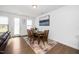 Dining area with hardwood floors, modern table and chairs, and natural lighting at 2129 Mars Hill Ln, Apex, NC 27502