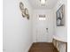 Bright entryway features a white door with glass, modern decor, and a stylish console table against white walls and wood floors at 2129 Mars Hill Ln, Apex, NC 27502